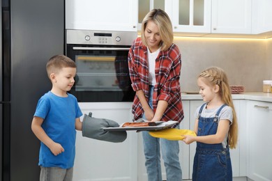 Little helpers. Children baking with their mother at home