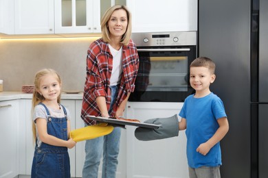 Little helpers. Children baking with their mother at home