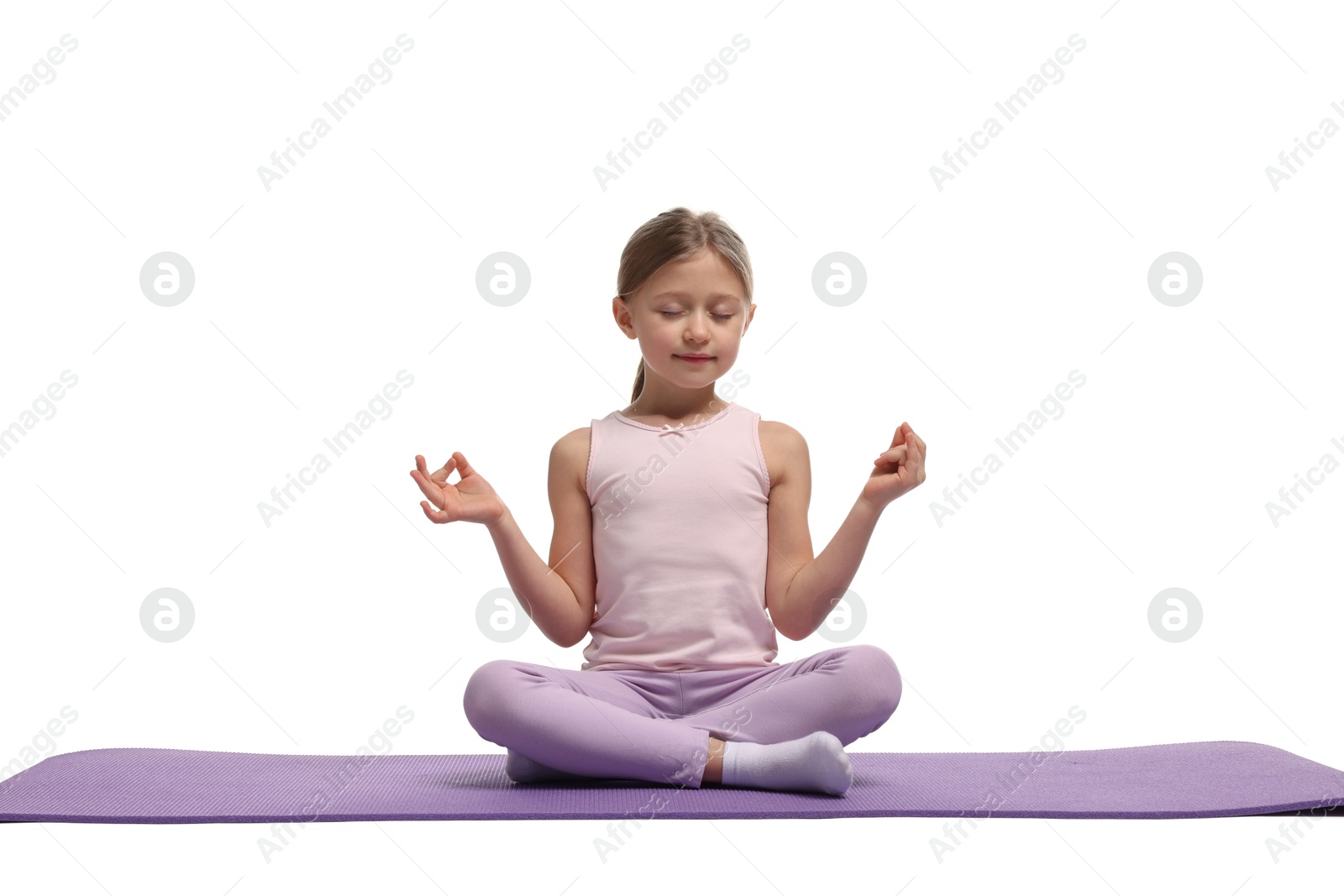 Photo of Little girl exercising on fitness mat against white background