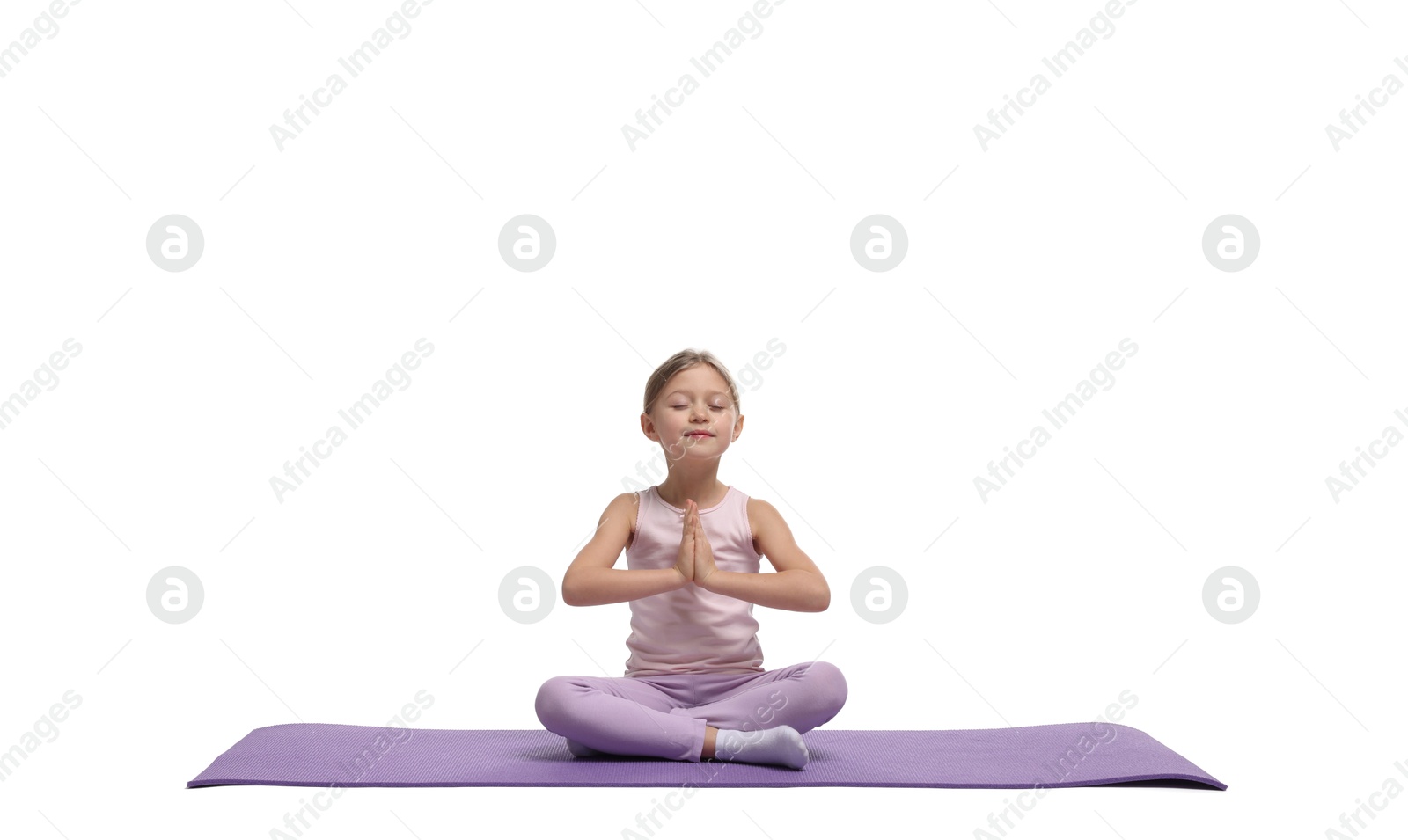 Photo of Little girl exercising on fitness mat against white background