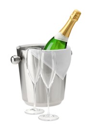 Photo of Bottle of champagne in ice bucket and empty glasses isolated on white