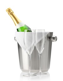 Photo of Bottle of champagne in ice bucket and empty glasses isolated on white