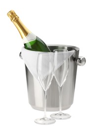 Photo of Bottle of champagne in ice bucket and empty glasses isolated on white