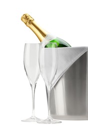 Photo of Bottle of champagne in ice bucket and empty glasses isolated on white