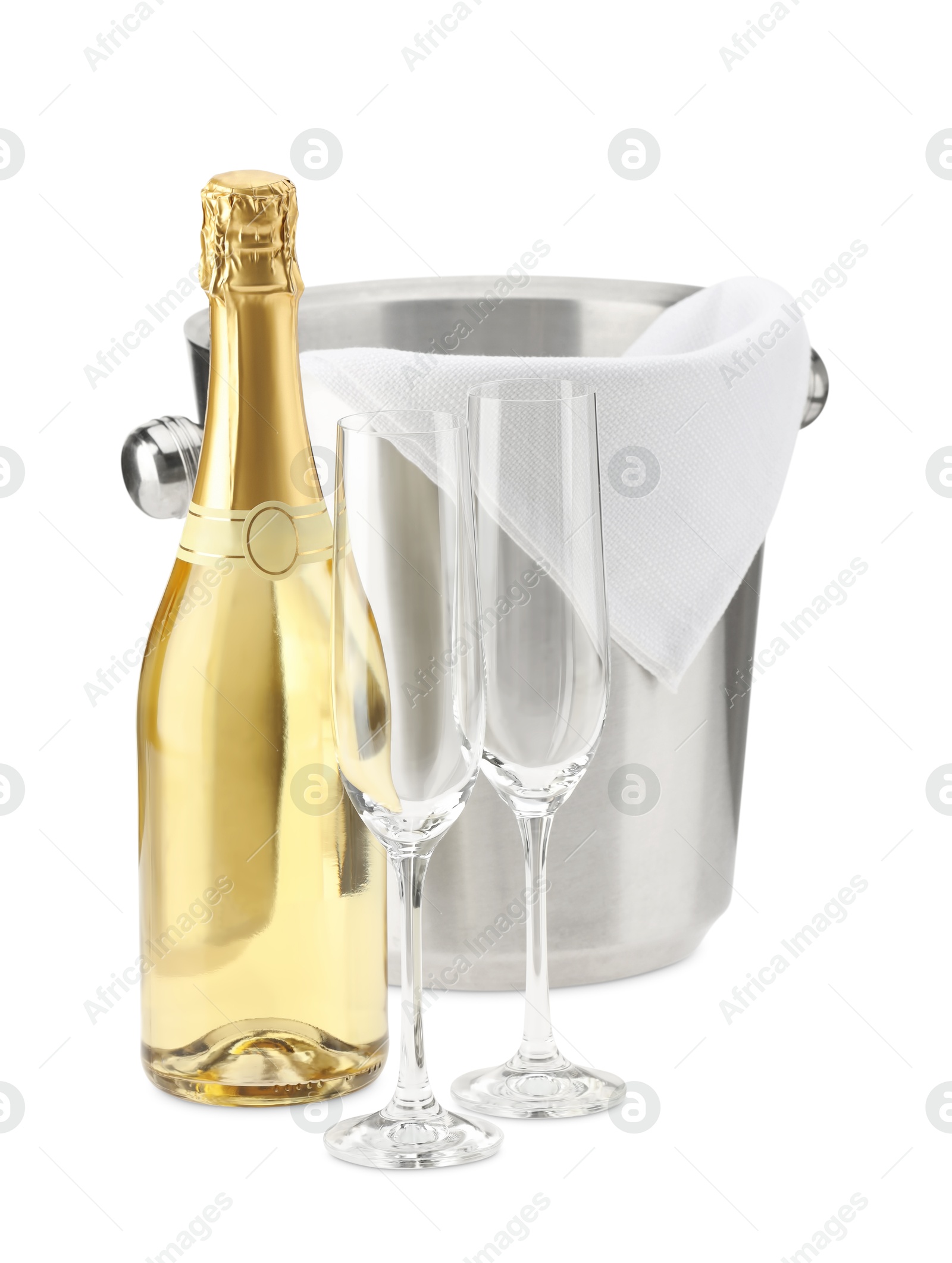 Photo of Bottle of champagne, ice bucket and empty glasses isolated on white