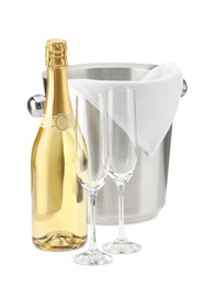 Photo of Bottle of champagne, ice bucket and empty glasses isolated on white