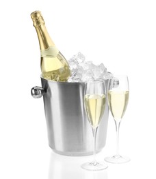 Photo of Champagne in glasses and ice bucket with bottle isolated on white