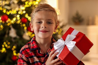 Little boy with Christmas box at home