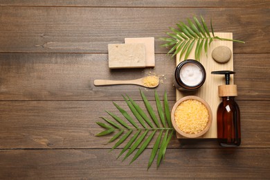 Photo of Spa composition with different cosmetic products on wooden table, flat lay