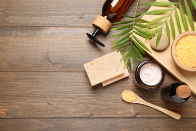 Photo of Spa composition with different cosmetic products on wooden table, flat lay. Space for text