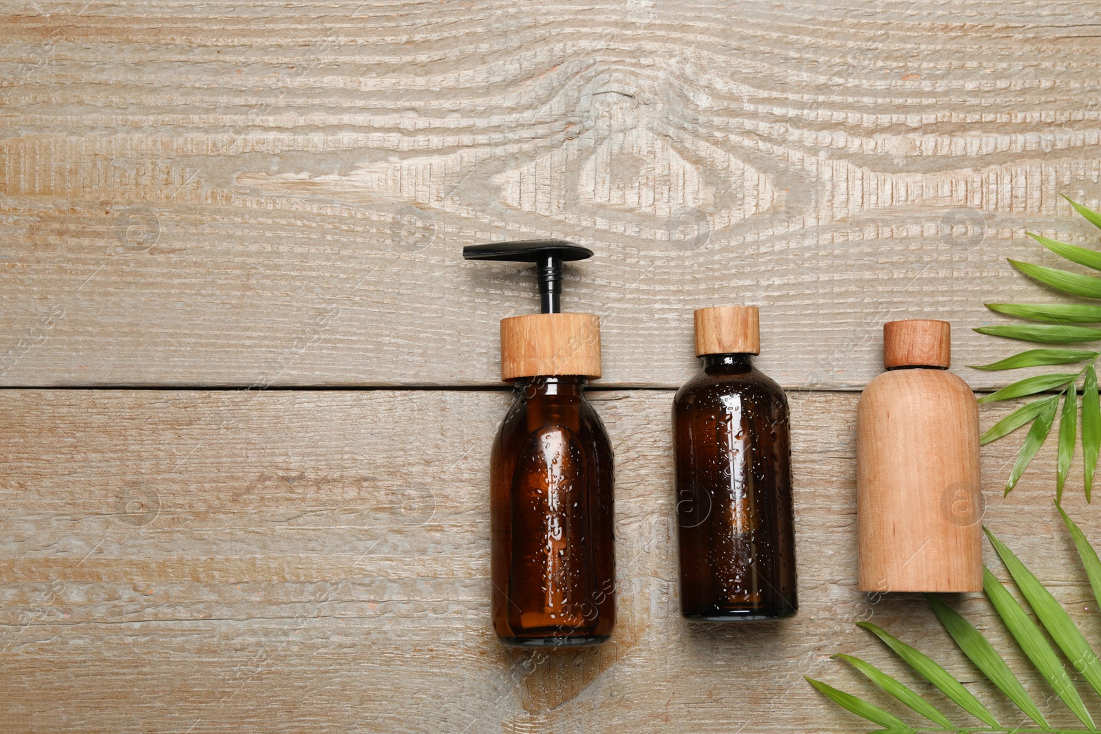 Photo of Spa composition with different cosmetic products on wooden table, flat lay. Space for text