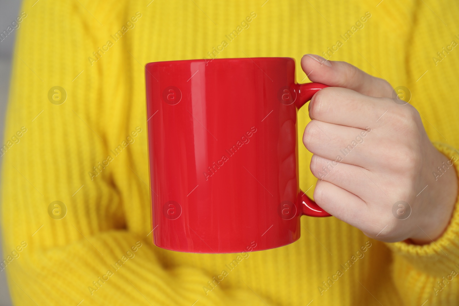 Photo of Woman with red ceramic cup, closeup. Mockup for design