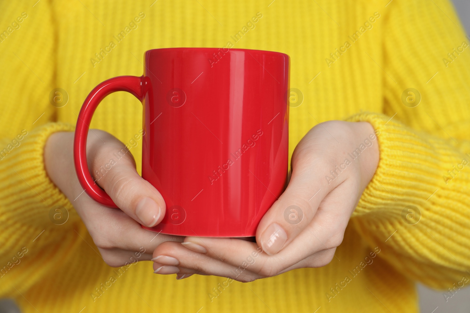 Photo of Woman with red ceramic cup, closeup. Mockup for design