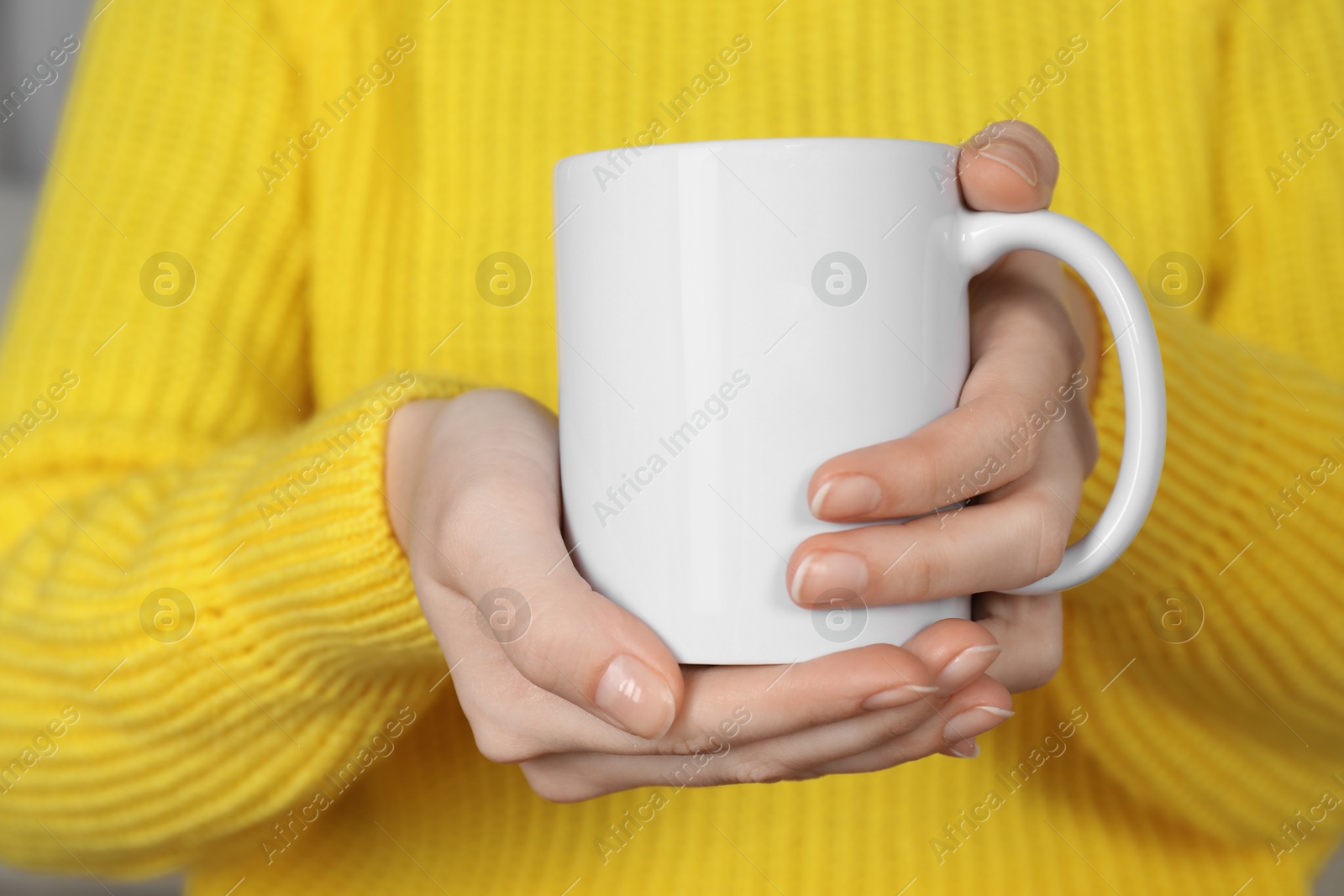 Photo of Woman with white ceramic cup, closeup. Mockup for design