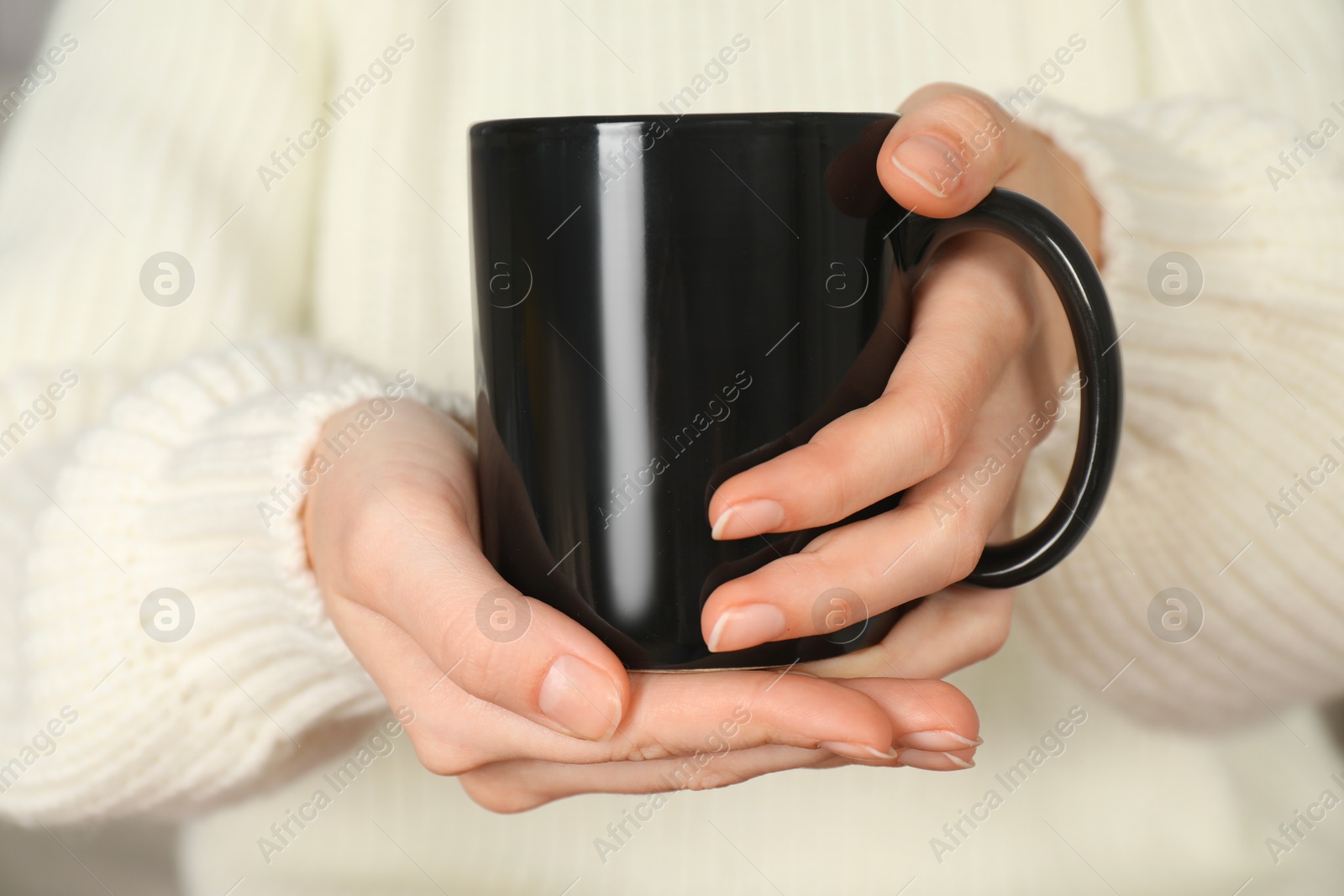 Photo of Woman with black ceramic cup, closeup. Mockup for design