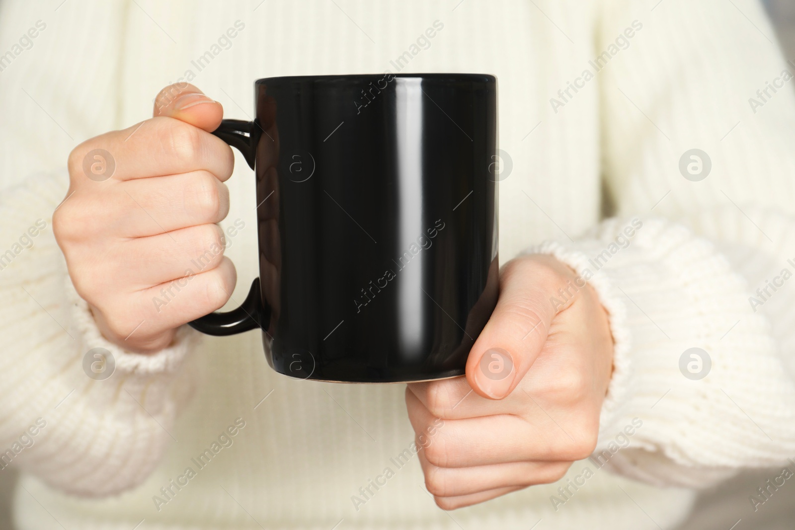 Photo of Woman with black ceramic cup, closeup. Mockup for design