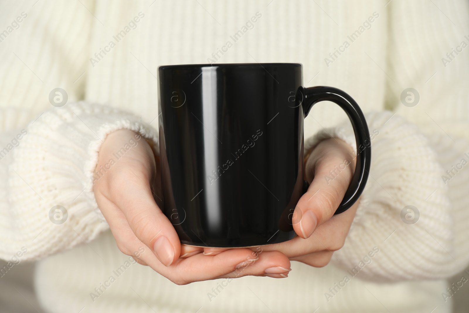 Photo of Woman with black ceramic cup, closeup. Mockup for design