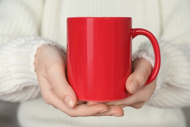 Photo of Woman with red ceramic cup, closeup. Mockup for design