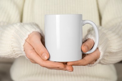 Photo of Woman with white ceramic cup, closeup. Mockup for design