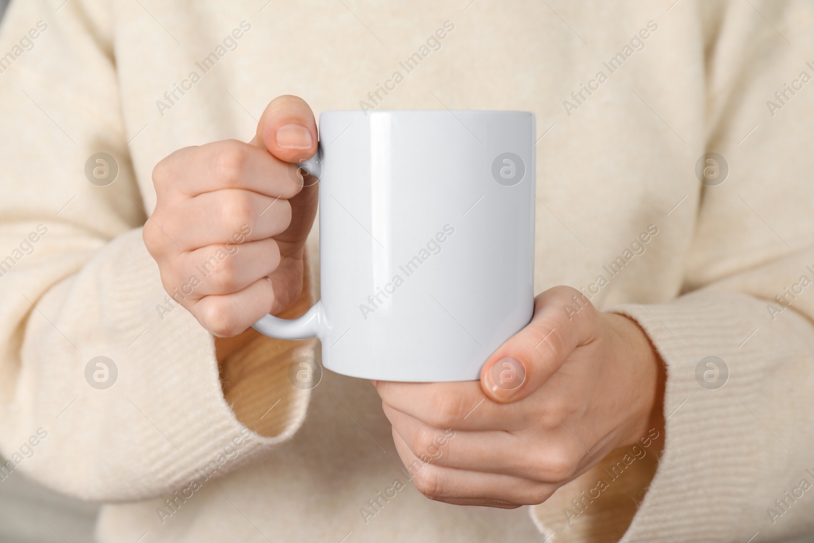 Photo of Woman with white ceramic cup, closeup. Mockup for design