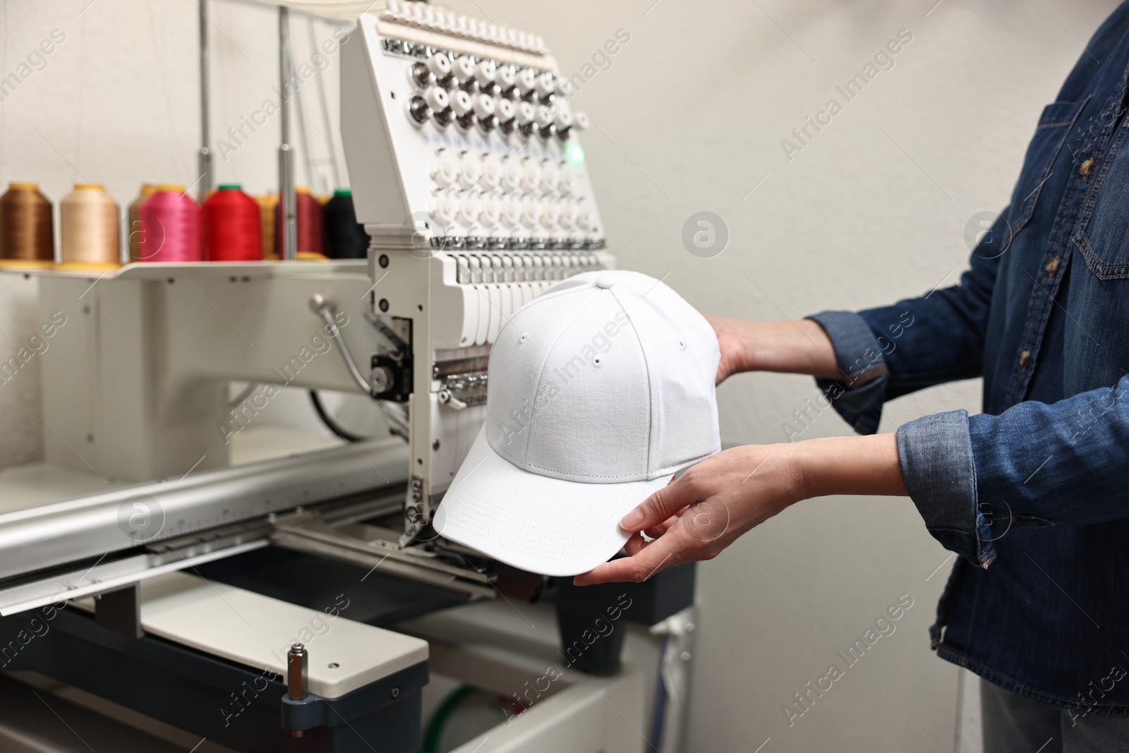 Photo of Woman with blank baseball cap for print indoors, closeup