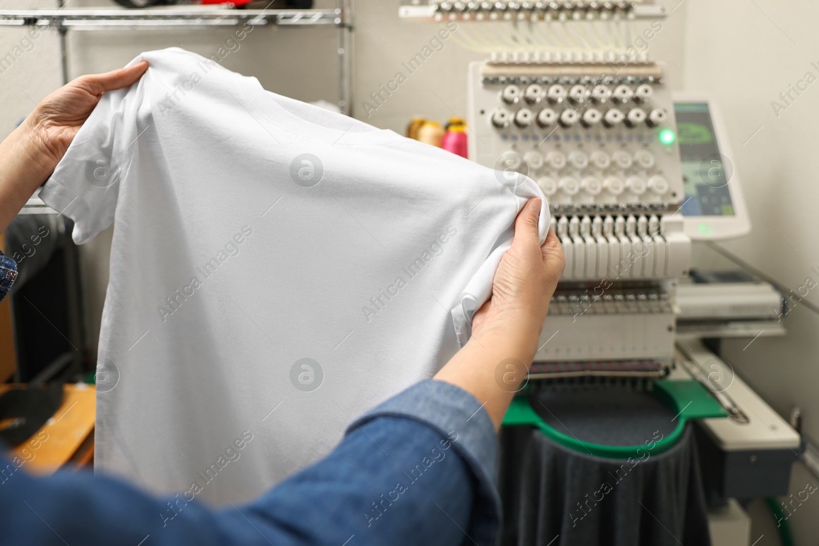 Photo of Woman with blank T-shirt for print indoors, closeup