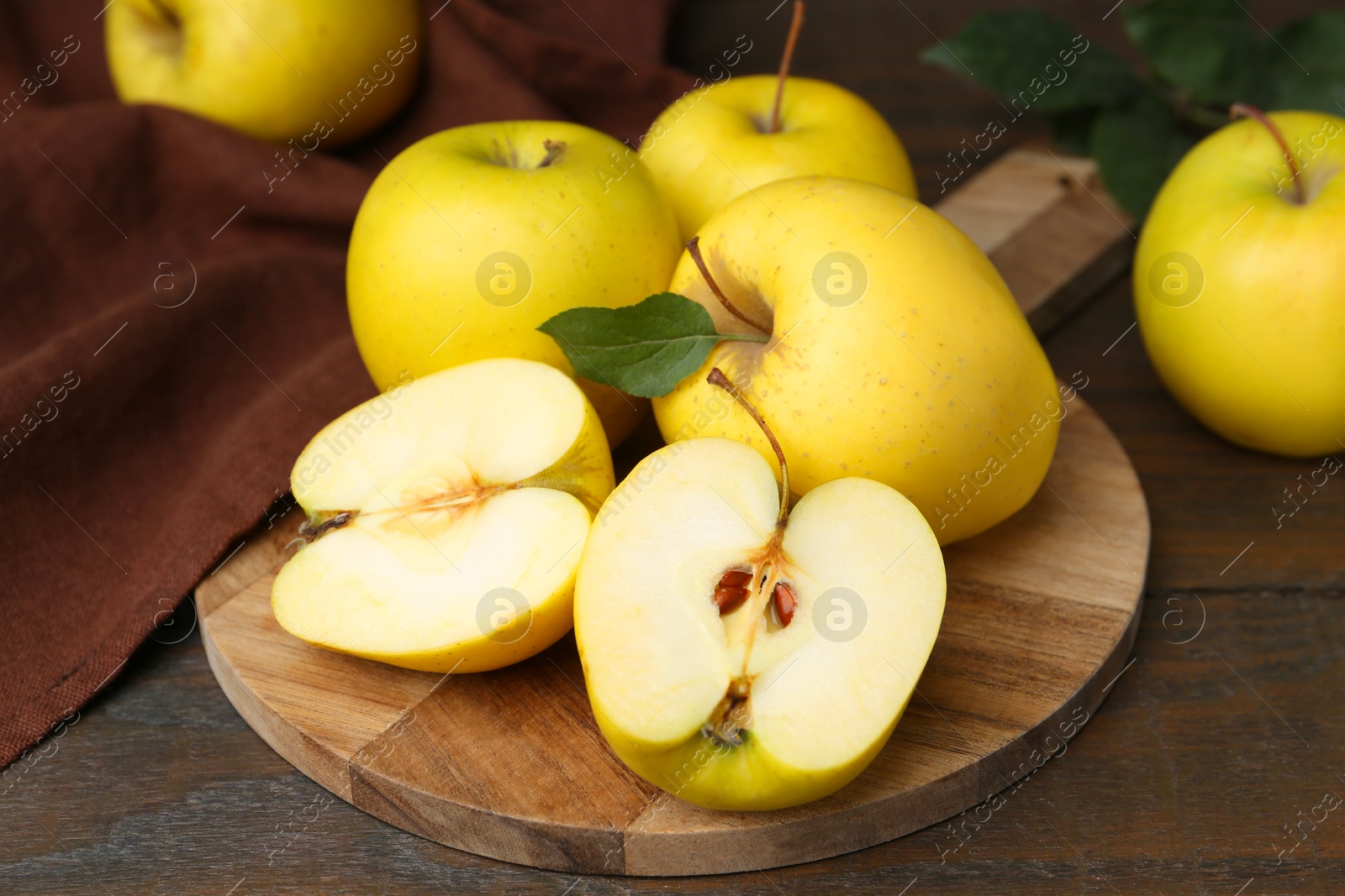 Photo of Fresh ripe yellow apples on wooden table, closeup