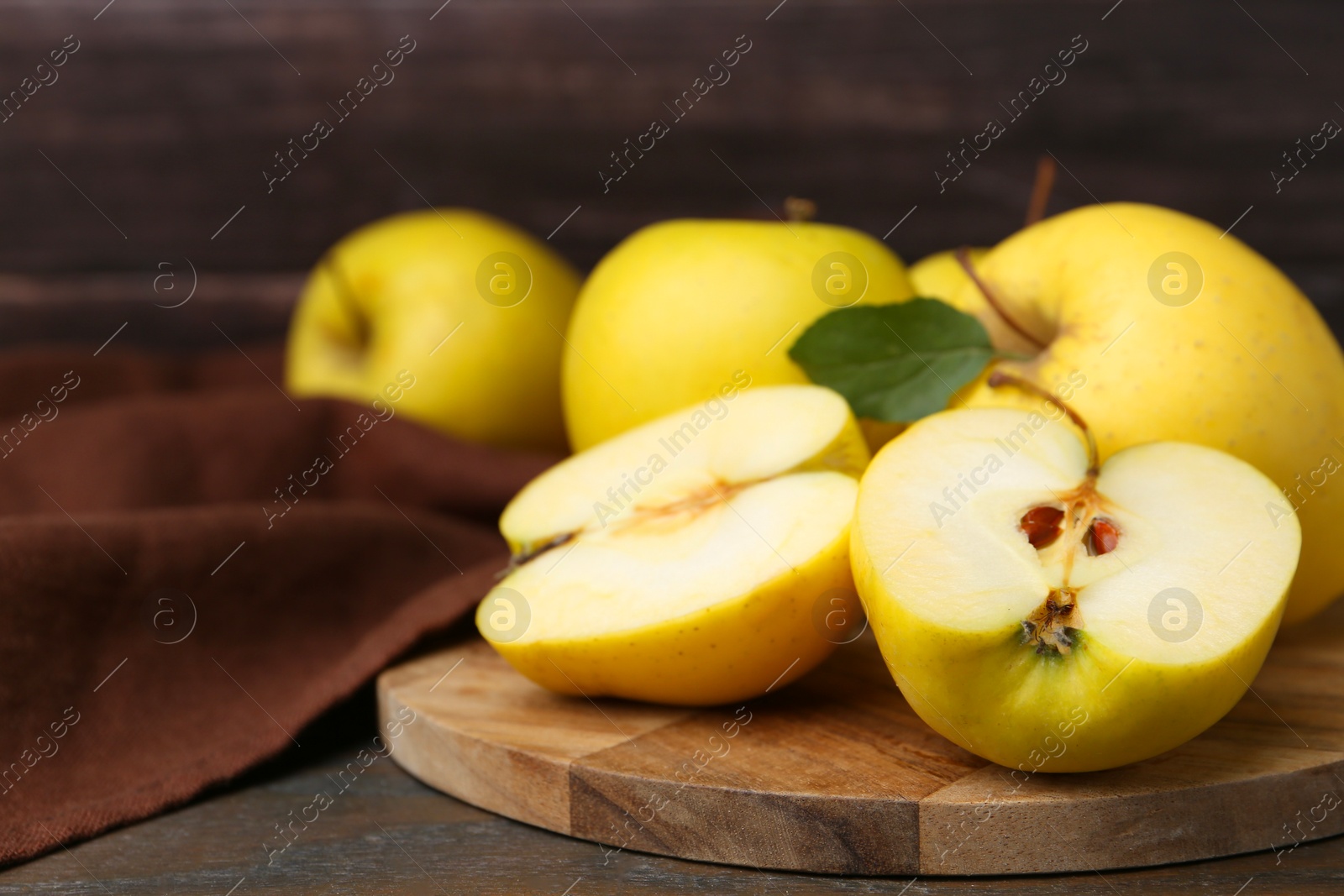 Photo of Fresh ripe yellow apples on wooden table, closeup. Space for text