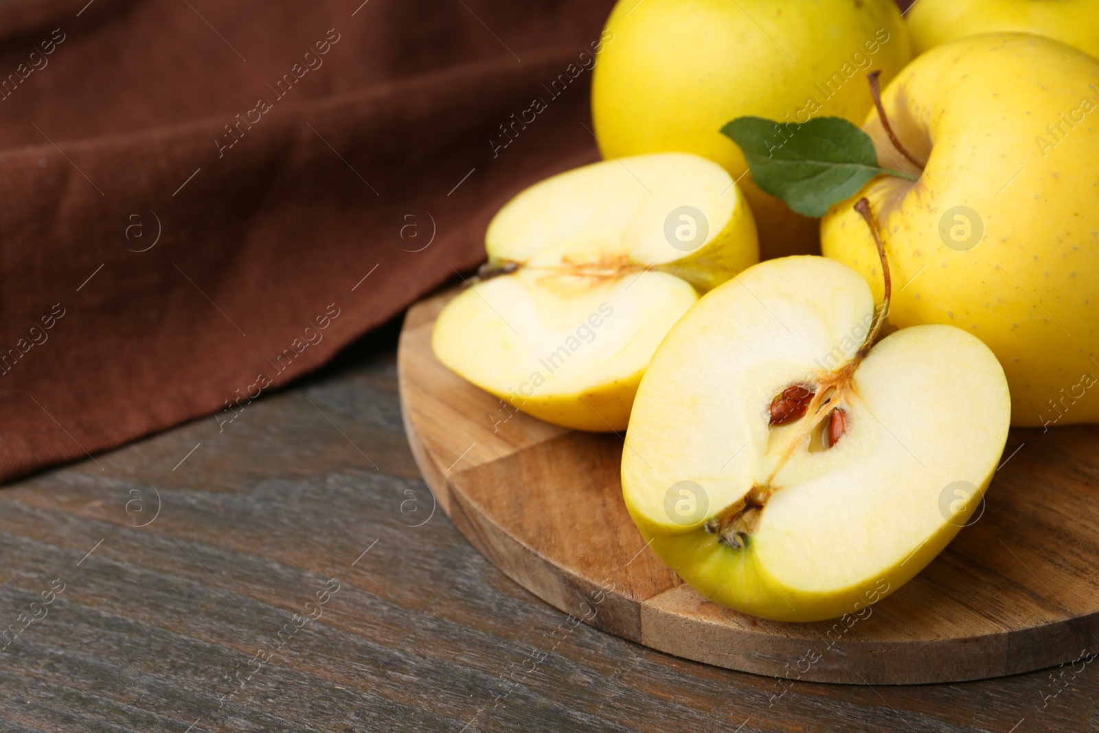 Photo of Fresh ripe yellow apples on wooden table, closeup. Space for text