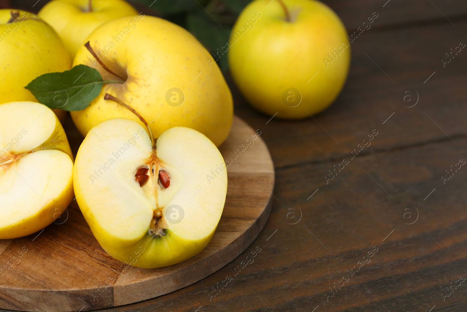 Photo of Fresh ripe yellow apples on wooden table, closeup. Space for text