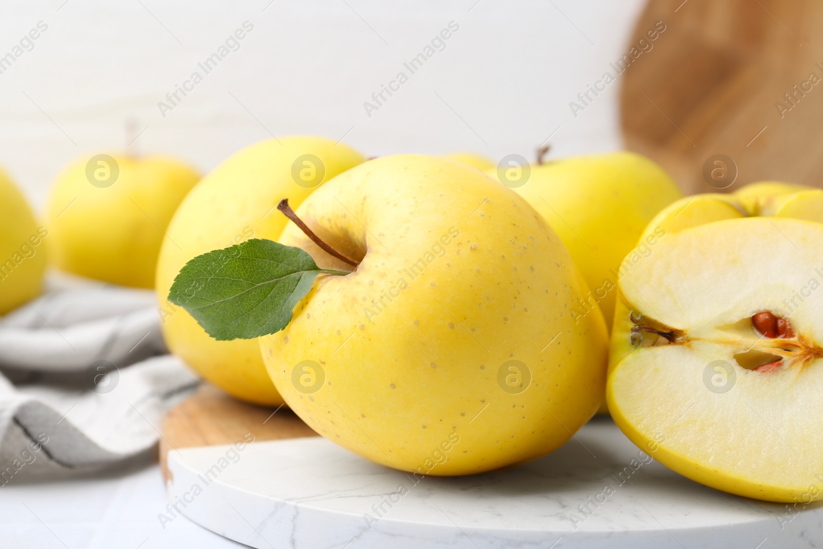 Photo of Fresh ripe yellow apples on white table, closeup