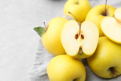 Photo of Fresh ripe yellow apples on grey table, closeup. Space for text