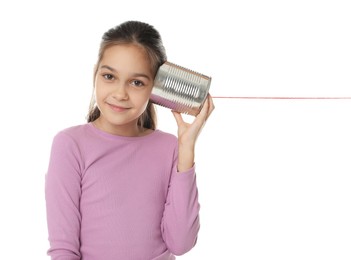 Photo of Girl using tin can telephone on white background