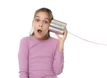 Girl using tin can telephone on white background