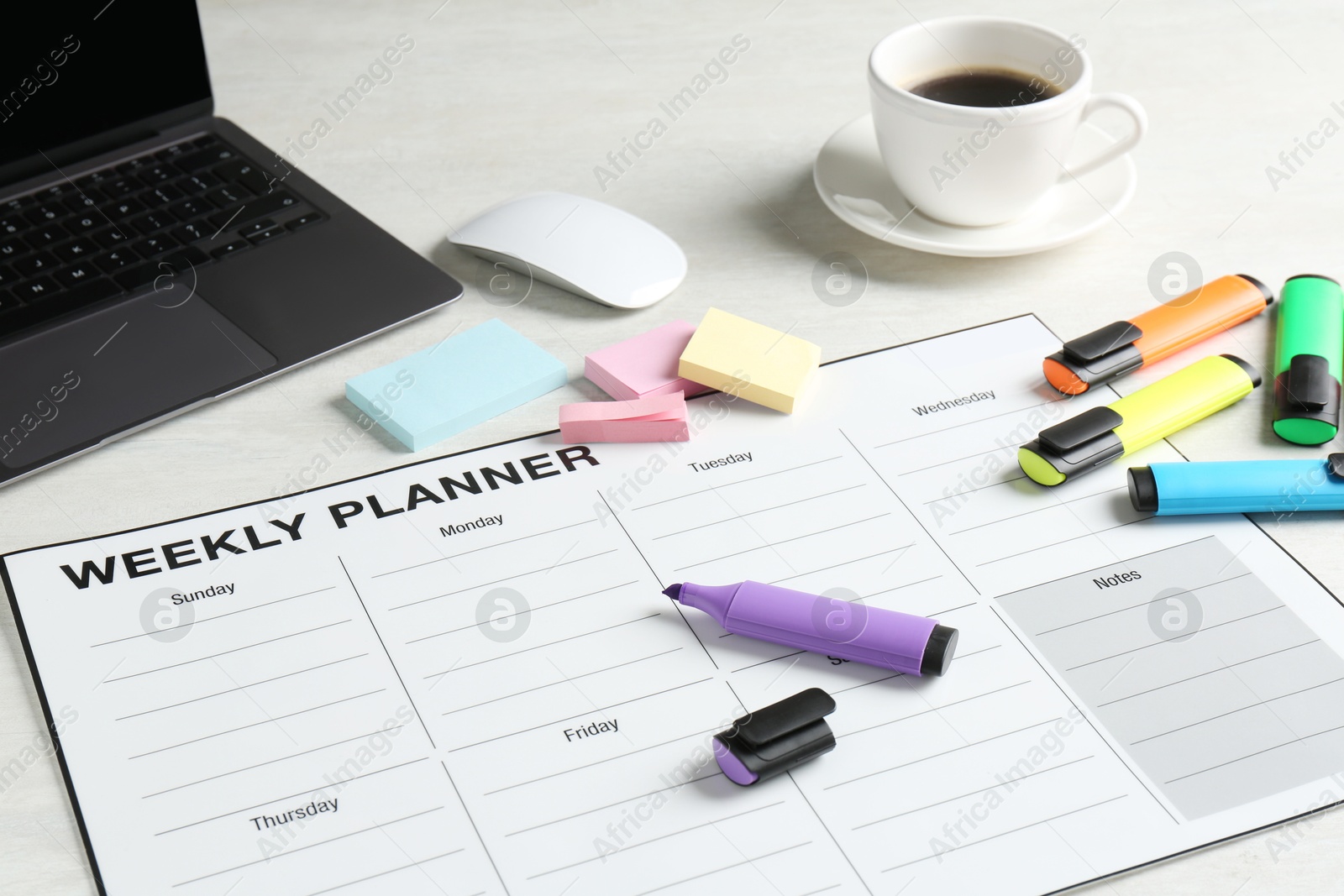 Photo of Timetable. Weekly planner, stationery, laptop and coffee on white table, closeup