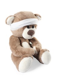 Photo of Teddy bear with bandage and thermometer isolated on white