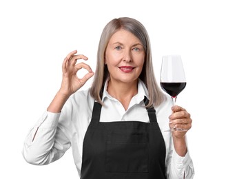 Senior woman with glass of wine showing okay gesture on white background