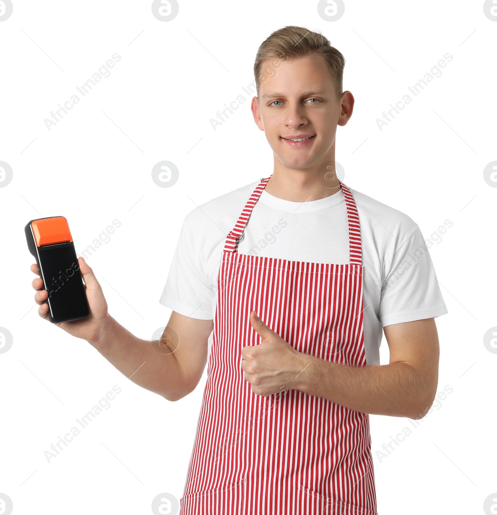 Photo of Happy young man in apron with payment terminal showing thumbs up on white background