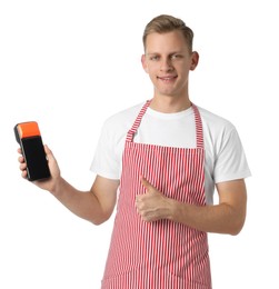 Happy young man in apron with payment terminal showing thumbs up on white background