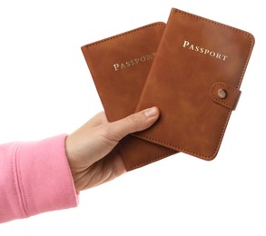 Photo of Woman holding passports in bright covers on white background, closeup