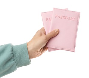 Photo of Woman holding passports in bright covers on white background, closeup