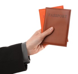 Photo of Woman holding passports in bright covers on white background, closeup