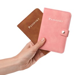 Photo of Woman holding passports in bright covers on white background, closeup