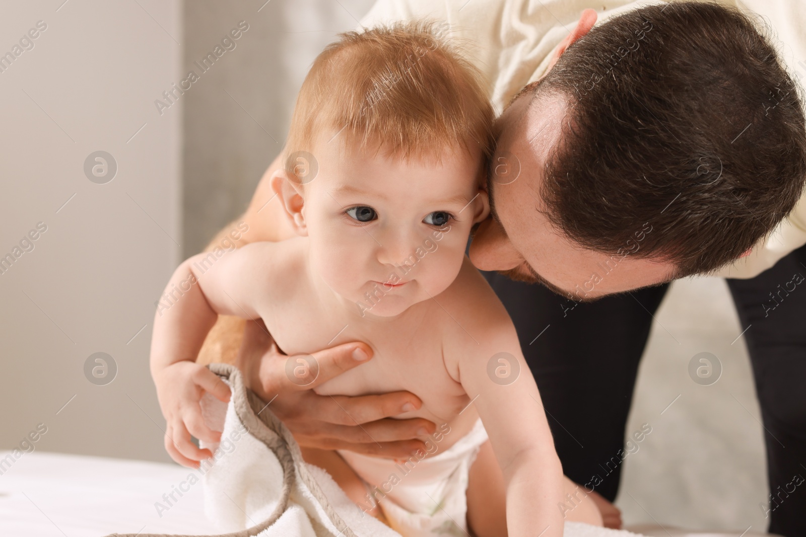 Photo of Father with his cute little baby indoors