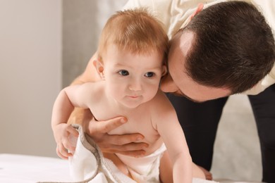 Photo of Father with his cute little baby indoors