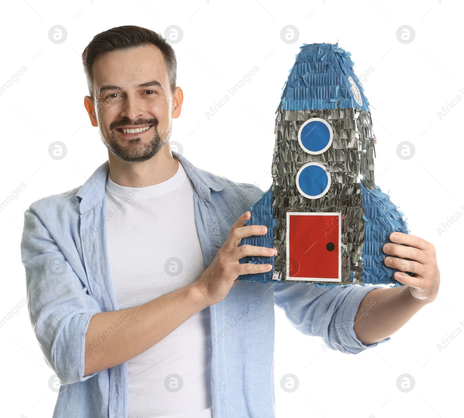 Photo of Happy man with rocket shaped pinata on white background