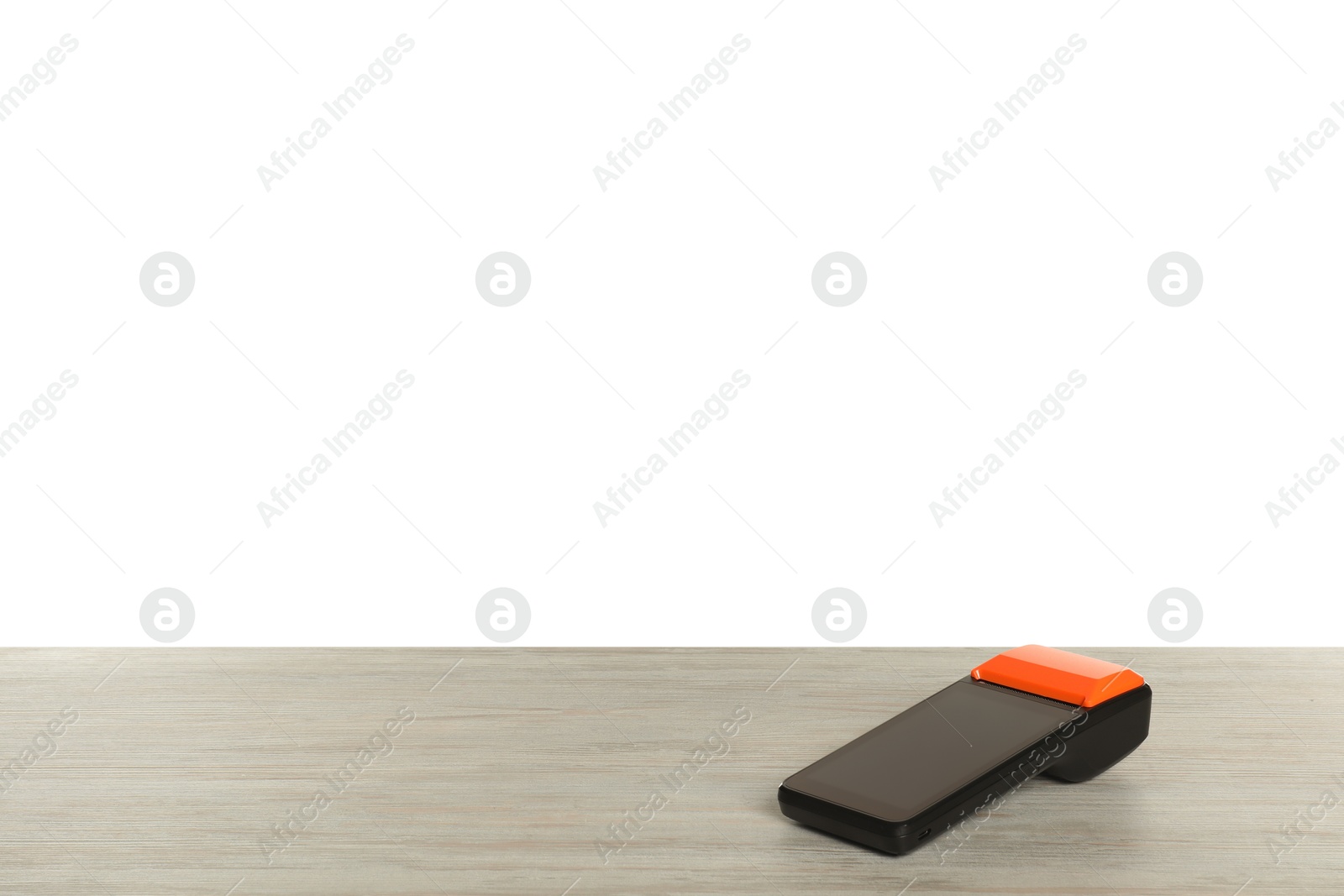 Photo of Payment terminal on wooden table against white background