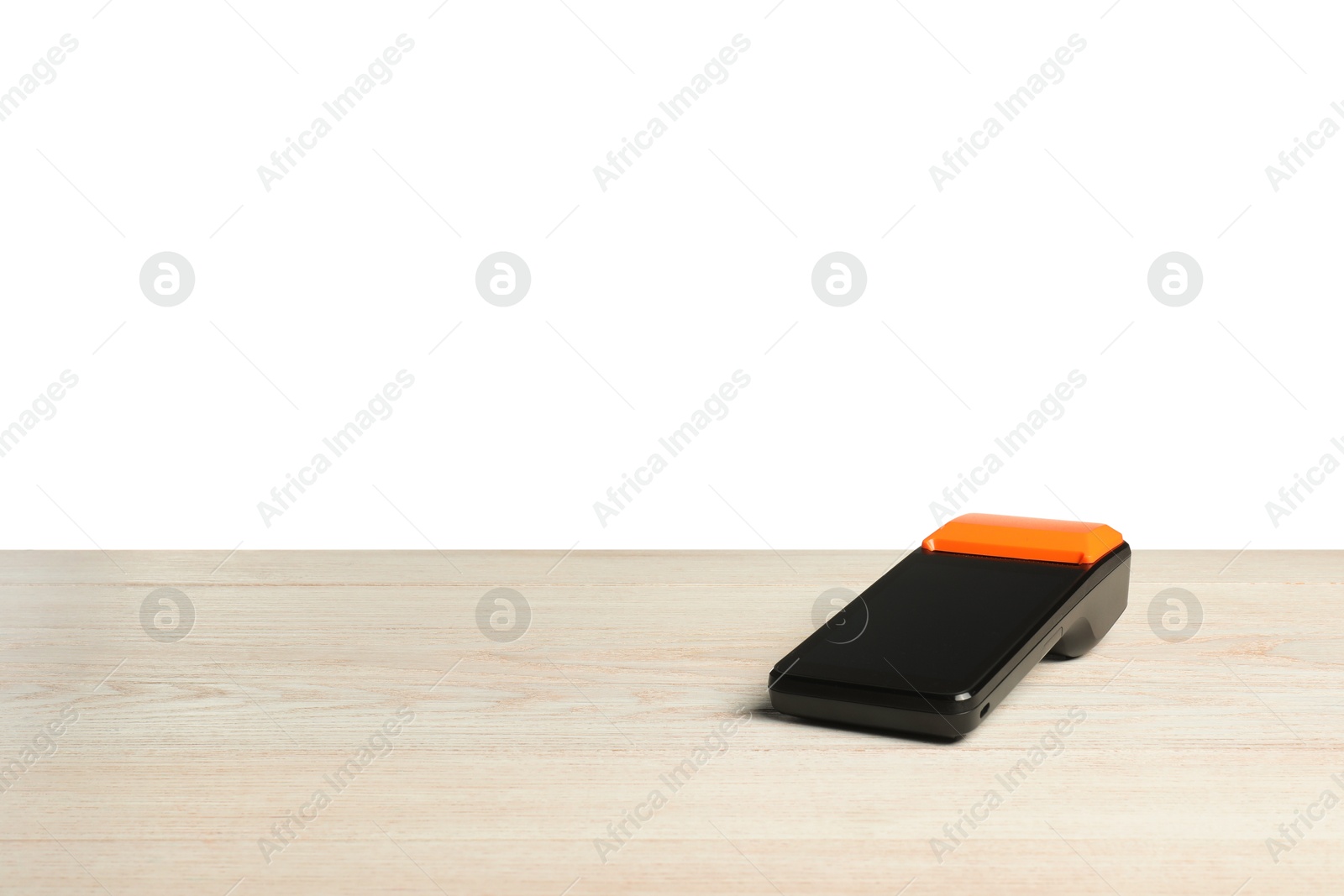 Photo of Payment terminal on wooden table against white background