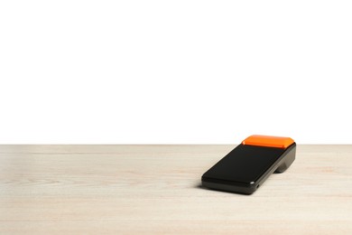 Photo of Payment terminal on wooden table against white background