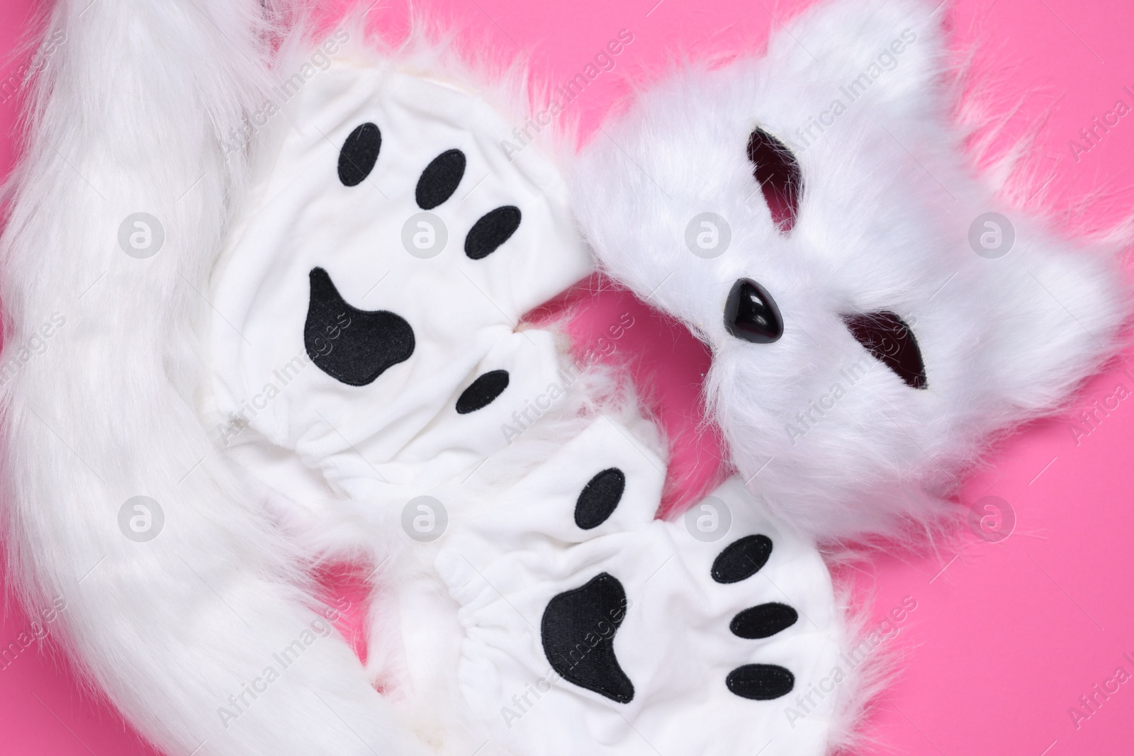 Photo of Quadrobics. Cat mask, tail and gloves on pink background, top view